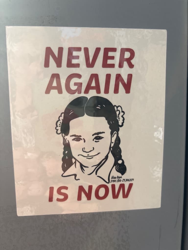 Never again is now sticker in The Hague